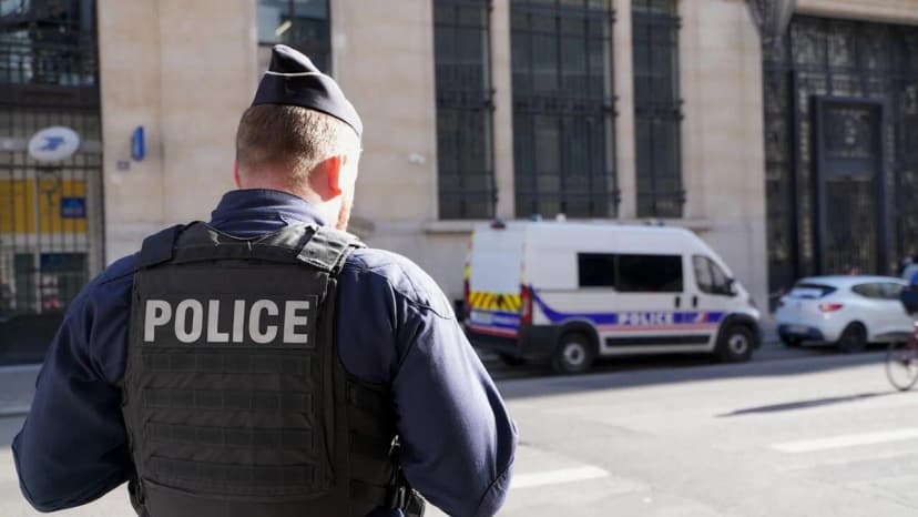 Police officers stand outside the Bank of America building in Paris after the attempted attack investigation.