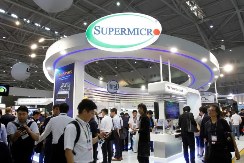Visitors walk past the Super Micro Computer booth at the Computex Taipei exhibition in Taipei, Taiwan