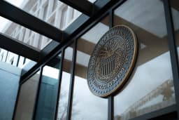 Traders work on the floor of the New York Stock Exchange on Wednesday as stocks fell following the Federal Reserve rate decision and hotter-than-expected inflation data