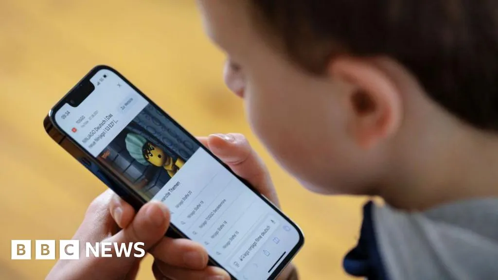 A boy uses a mobile phone in a file photo illustrating Austria's planned social media age ban for children under 14