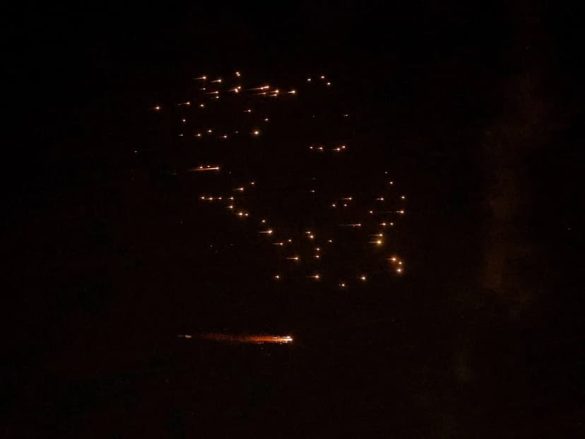 Rocket trails illuminate the night sky over the Israeli coastal city of Netanya during a barrage of Iranian missile attacks on March 18, 2026 (Jack Guez/AFP)