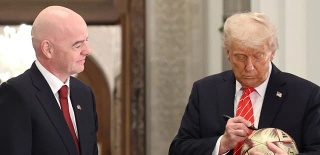 FIFA president Gianni Infantino and U.S. President Donald Trump sign a football during a 2026 World Cup ceremony in Doha in May 2025.