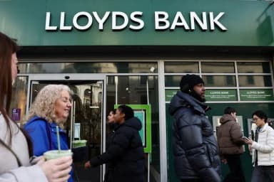 People walk past a Lloyds Bank branch in London in a Reuters file photo by Jack Taylor