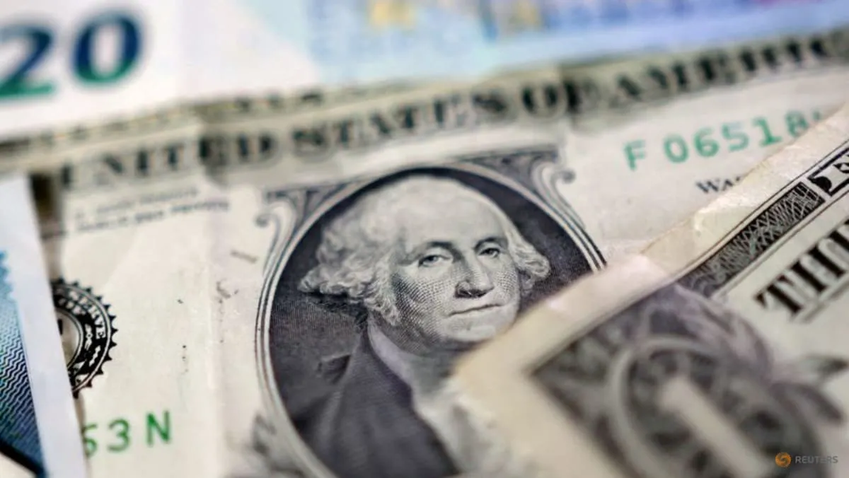 US dollar banknotes arranged in a stack, illustrating the greenback's weekly decline amid global central bank hawkish pivot