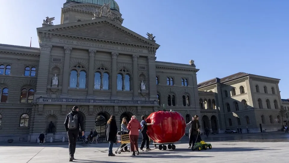 Supporters of the Food Protection Initiative with an oversized tomato outside the Federal Palace in Bern on February 27, 2026