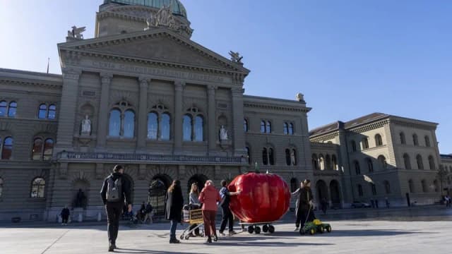 Supporters of the Food Protection Initiative with an oversized tomato outside the Federal Palace in Bern on February 27, 2026