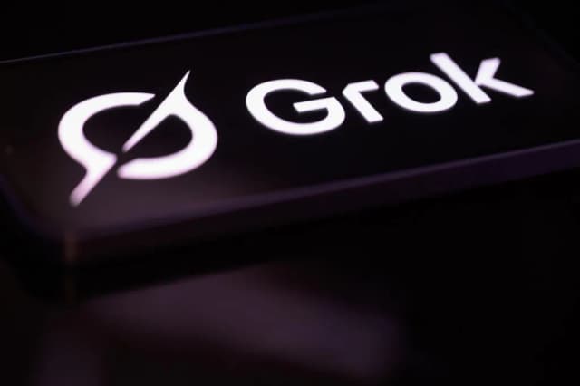 The Grok AI chatbot logo displayed on a screen, the artificial intelligence tool developed by Elon Musk's xAI company that is the subject of a class-action lawsuit filed by Tennessee teenagers