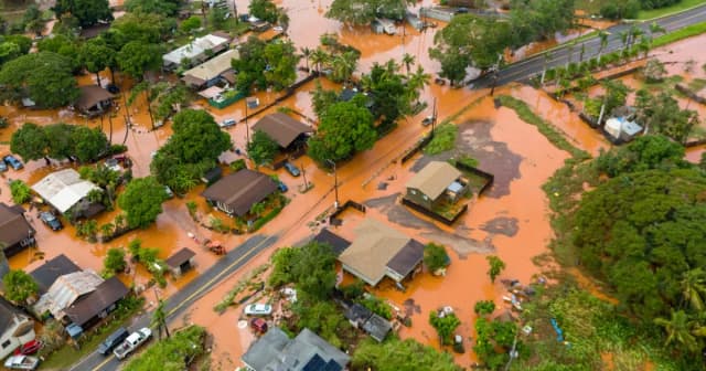 Aerial view of flood-damaged homes and mud-covered streets in Waialua on Oahu's North Shore after Hawaii's worst flooding in more than twenty years