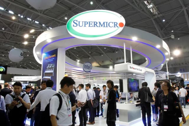 Visitors walk past the Super Micro Computer booth at the Computex Taipei exhibition in Taipei, Taiwan
