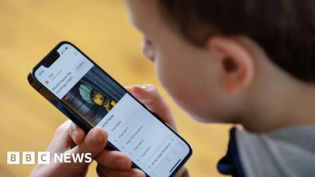 A boy uses a mobile phone in a file photo illustrating Austria's planned social media age ban for children under 14