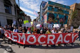 Demonstrators march through the Country Club Plaza during a No Kings protest in Kansas City, Missouri, on March 28, 2026