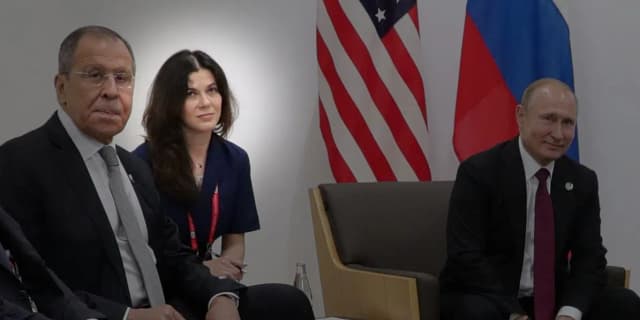 Vladimir Putin at the G20 summit in Osaka 2019, flanked by delegates including Foreign Minister Lavrov, where interpreter Daria Boyarskaya translated during the Putin-Trump bilateral meeting