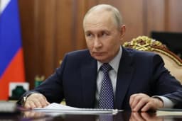 Russian President Vladimir Putin listens during a Kremlin meeting in Moscow in an AP pool photo used as cover art for coverage of the Easter ceasefire announcement