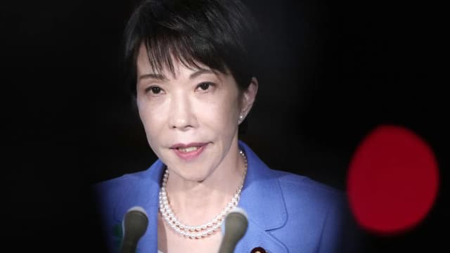 Japan Prime Minister Sanae Takaichi speaks to reporters at her office in Tokyo before the cabinet approved new lethal arms export rules