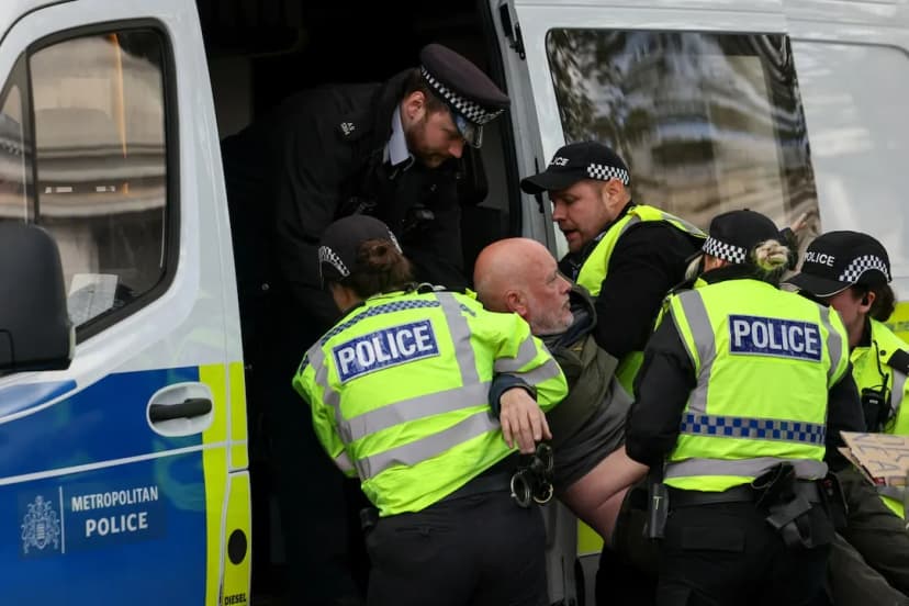Police detain a protester during the Palestine Action demonstration in Trafalgar Square in London on April 11, 2026