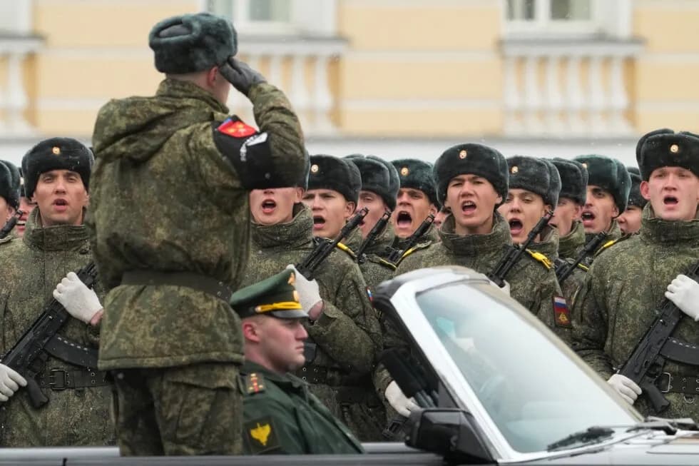 Uniformed troops march in formation during a Victory Day parade rehearsal