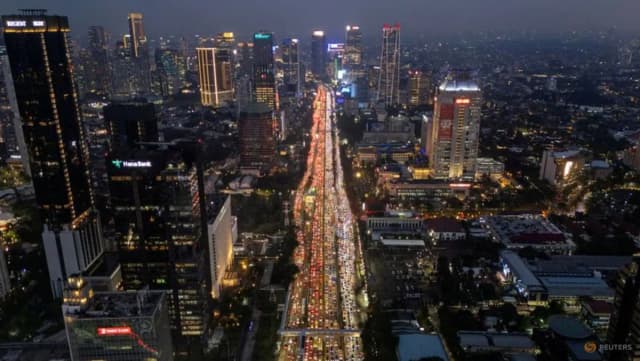Traffic moves through Jakarta's business district in a Reuters photo by Willy Kurniawan illustrating Indonesia's fiscal and market pressures