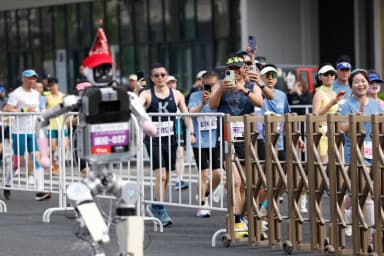 Honor's humanoid robot Shandian runs during the Beijing E-Town half-marathon for robots in Beijing on April 19, 2026