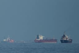 Oil tankers and cargo ships line up in the Strait of Hormuz near Khor Fakkan in the United Arab Emirates in a file AP photo.