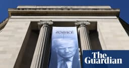A large Donald Trump banner hangs on the Justice Department building in Washington after the department opened a criminal inquiry the SPLC says is focused on its past informant program