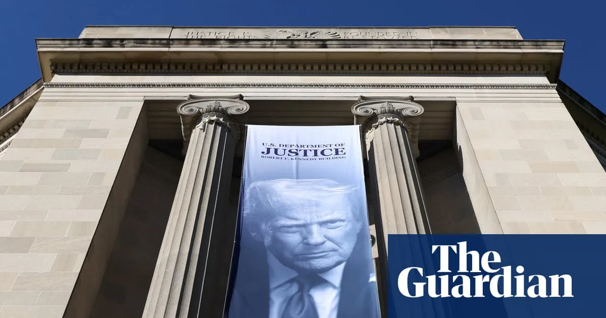 A large Donald Trump banner hangs on the Justice Department building in Washington after the department opened a criminal inquiry the SPLC says is focused on its past informant program