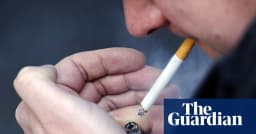 A man smokes a cigarette in Britain as parliament finalises a generational tobacco-ban law