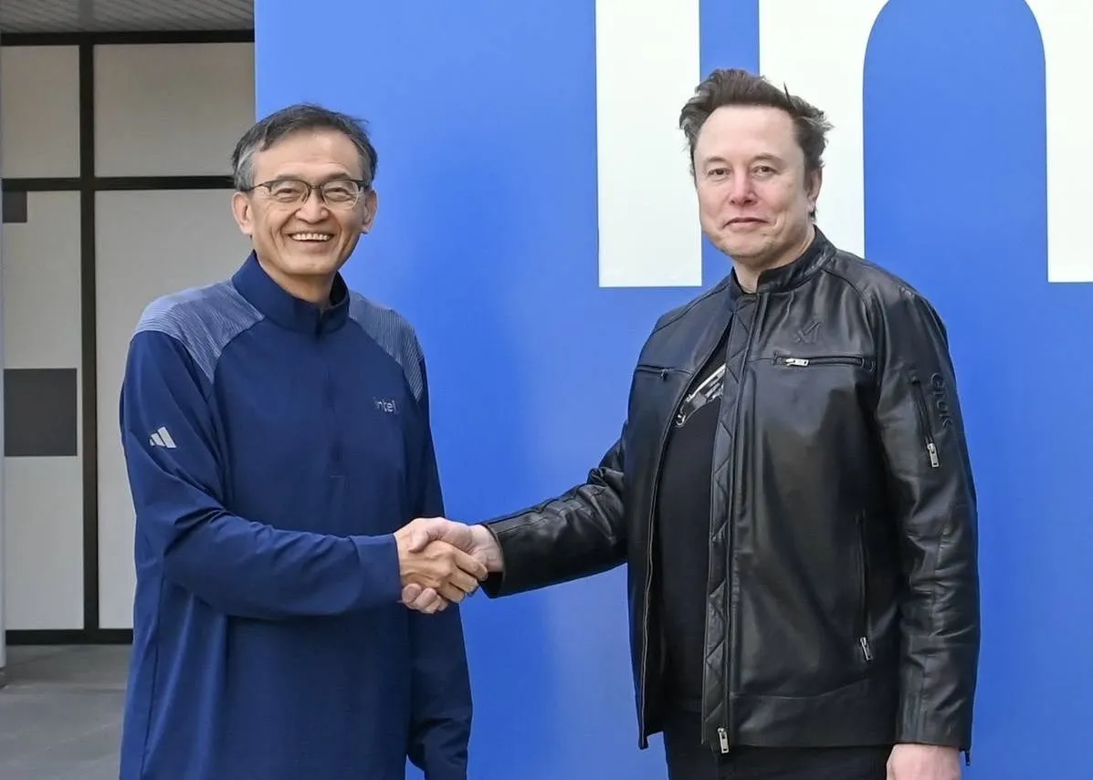 Intel chief executive Lip-Bu Tan shakes hands with Elon Musk in a company photo released around the Terafab partnership