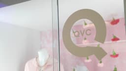 Stage setup at a QVC promotional event, illustrating the television retailer behind the Chapter 11 filing