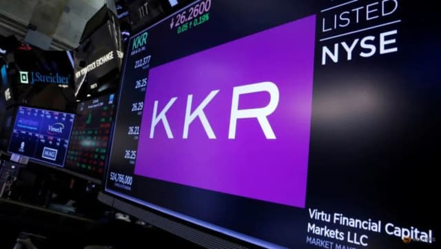 Trading screens for KKR & Co on the floor of the New York Stock Exchange in New York, illustrating KKR's $820 million Samsung SDS convertible-bond investment