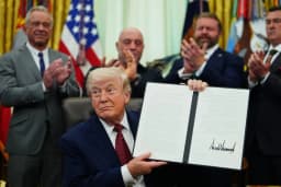 President Donald Trump signs a psychedelic-drug executive order in the Oval Office as Robert F. Kennedy Jr., Joe Rogan and veteran advocates look on