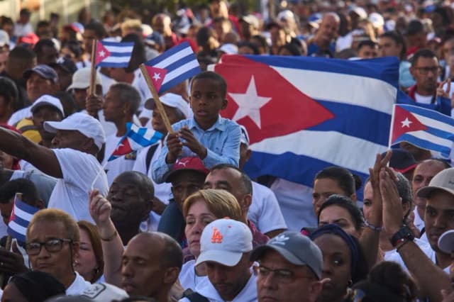 People attend a rally marking the anniversary of the Cuban Revolution's socialist declaration in Havana.