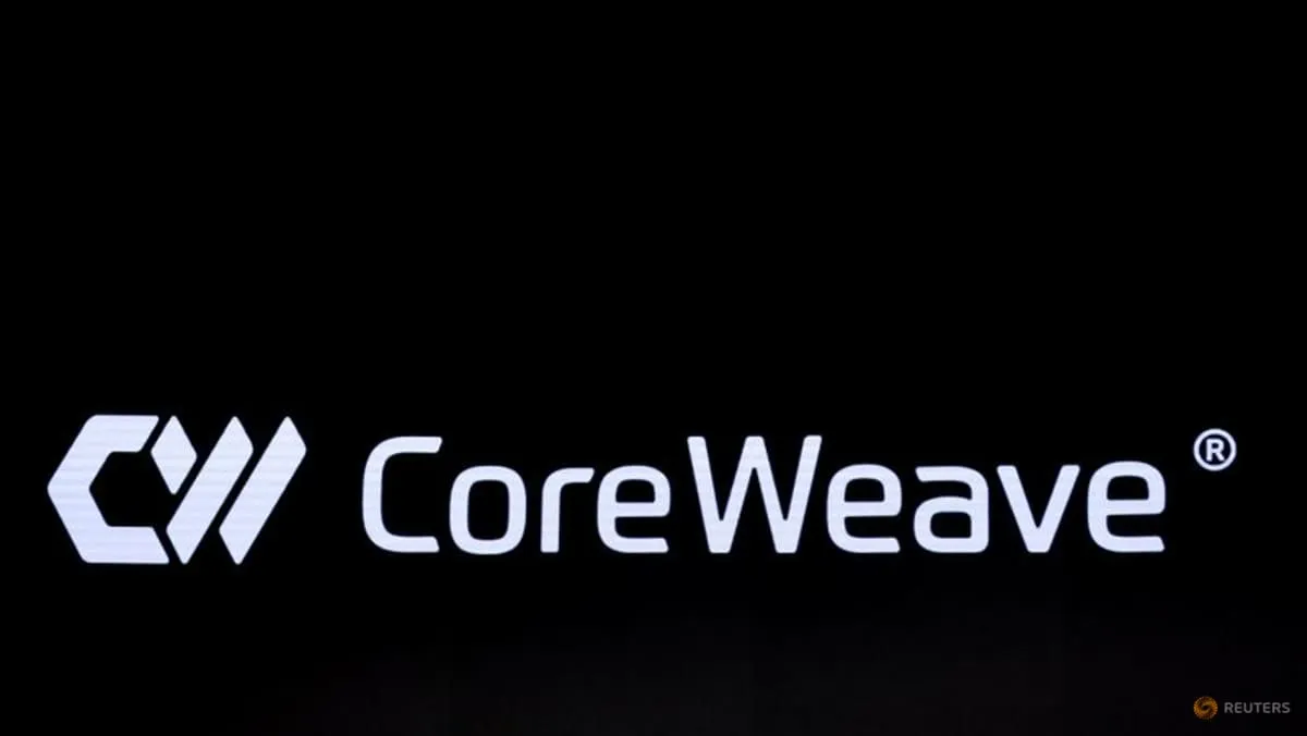 A screen displaying the CoreWeave logo in New York in a Reuters photo illustrating Meta’s expanded AI cloud agreement with the company