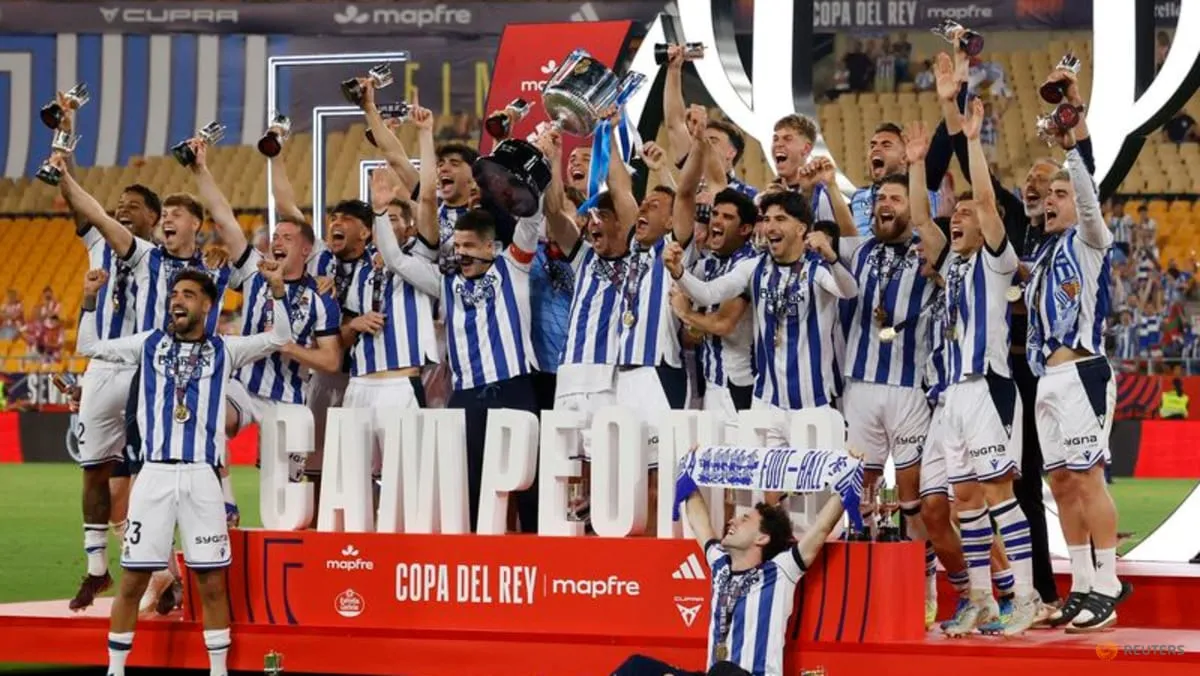 Real Sociedad captain Mikel Oyarzabal celebrates with teammates after the Copa del Rey final win over Atletico Madrid in Seville on April 18, 2026