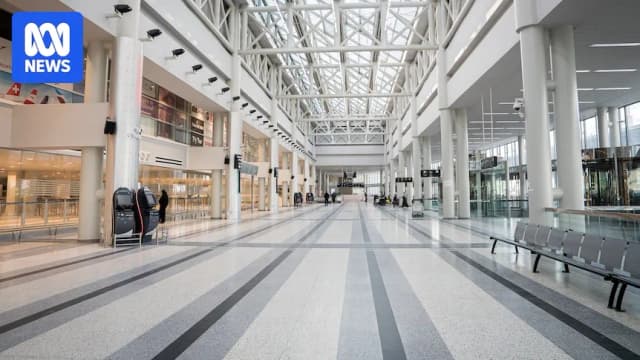 Travellers move through the departure hall at Beirut-Rafic Hariri Airport during reduced wartime operations