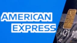 American Express credit card shown in front of the American Express logo in a Reuters illustration