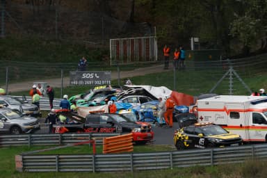 Emergency vehicles and damaged race cars are seen after a multi-car crash during the Nürburgring qualifier.