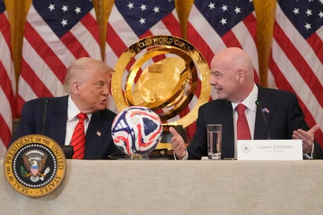 President Donald Trump speaks with FIFA President Gianni Infantino during a White House World Cup task force meeting