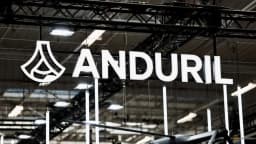 The Anduril Industries logo on a dark display panel at an air show.