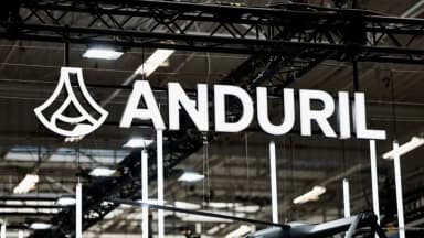 The Anduril Industries logo on a dark display panel at an air show.