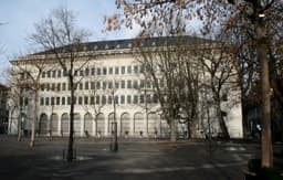 A grand stone building housing the Swiss National Bank in Zurich, photographed from street level