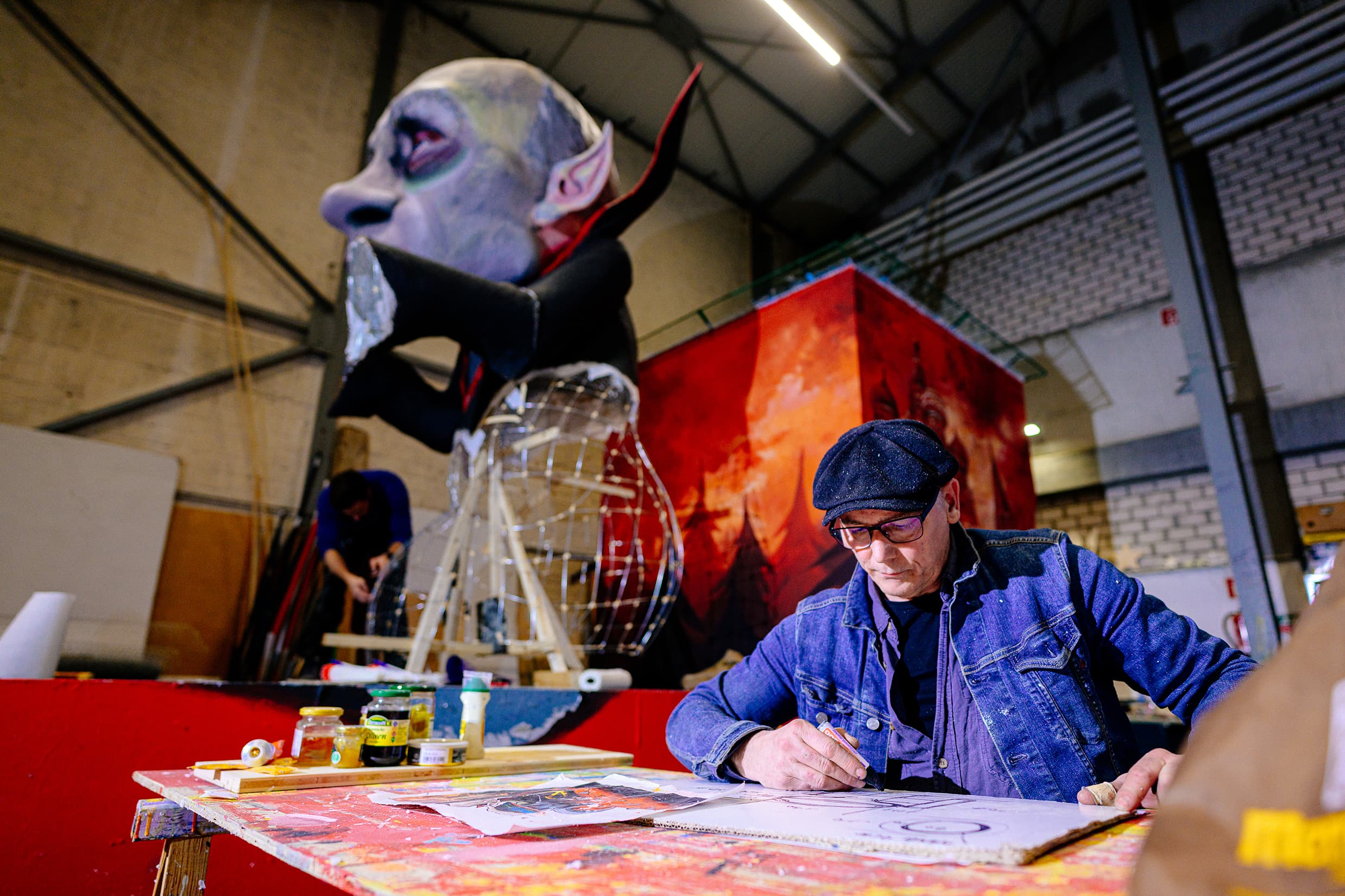 A large colourful carnival float under construction in a workshop ahead of the Rose Monday parade in Cologne
