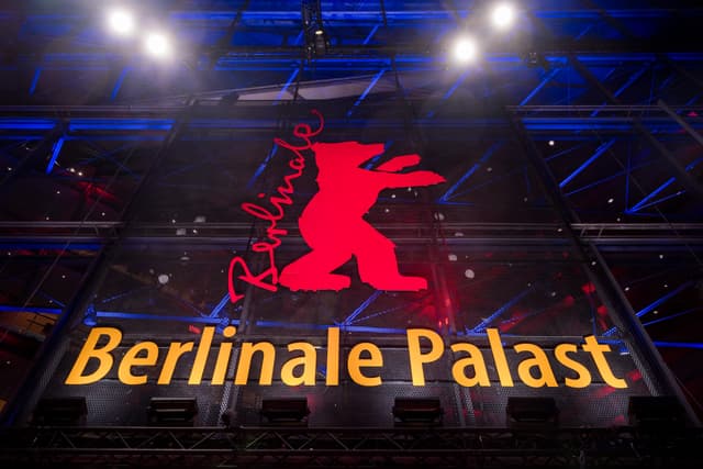 The illuminated Berlinale Palast building exterior at night during the Berlin International Film Festival