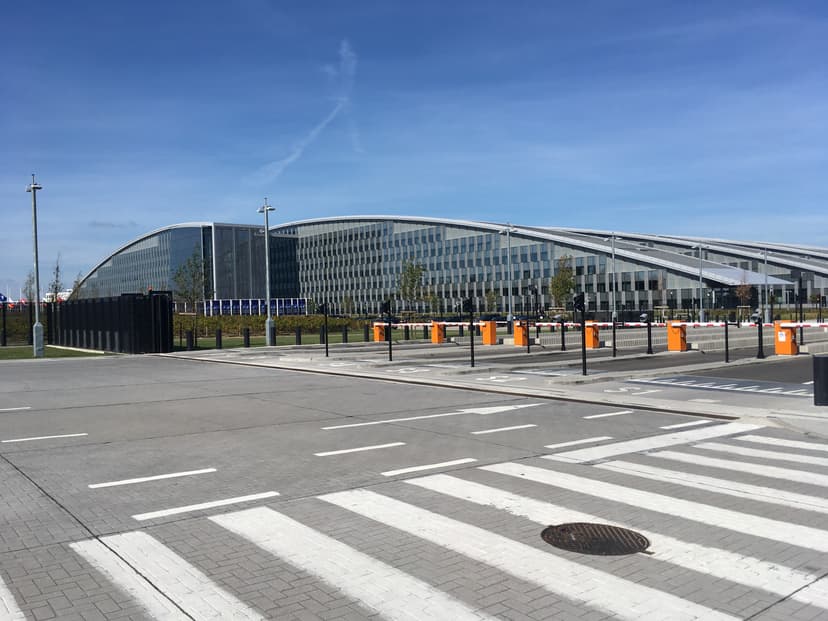 The new NATO headquarters building in Brussels, a modern glass and steel structure seen from an exterior viewpoint