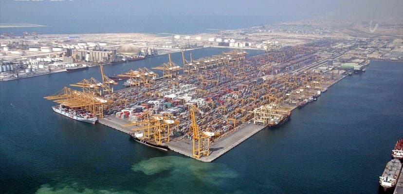 Aerial view of a large container port with cranes and shipping infrastructure in Dubai