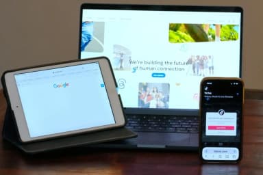Home pages for Meta, Google and TikTok displayed on devices in Sydney as Australia unveils a proposed levy tied to news-payment deals