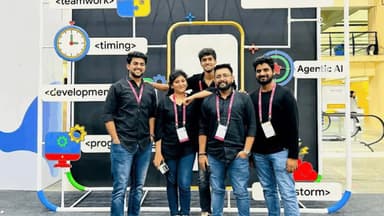 A group of Astreya staff members posing in front of a trade-show display featuring software-development and AI signage
