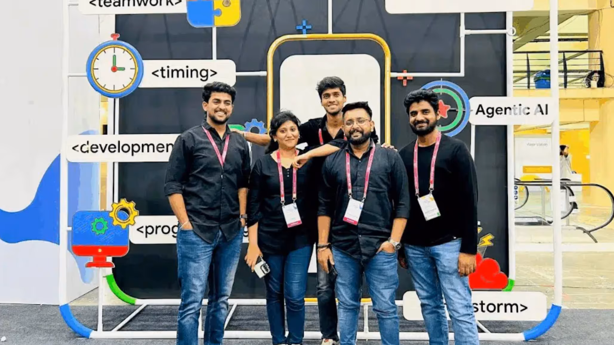A group of Astreya staff members posing in front of a trade-show display featuring software-development and AI signage