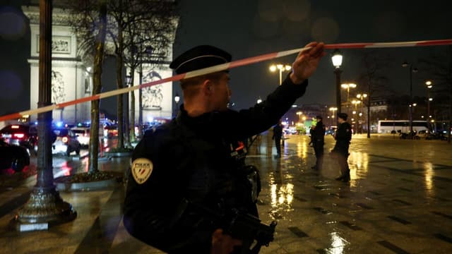 French police officers block access to the Arc de Triomphe in Paris after a knife attack on February 13, 2026