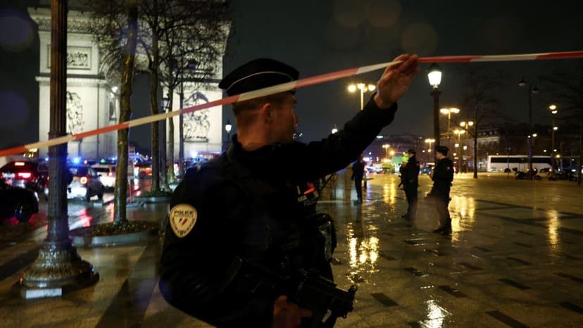 French police officers block access to the Arc de Triomphe in Paris after a knife attack on February 13, 2026