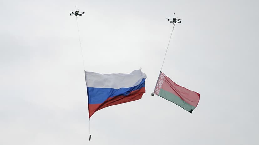 Two national flags suspended from drones above a winter sports venue, symbolizing the return of national symbols to Paralympic competition